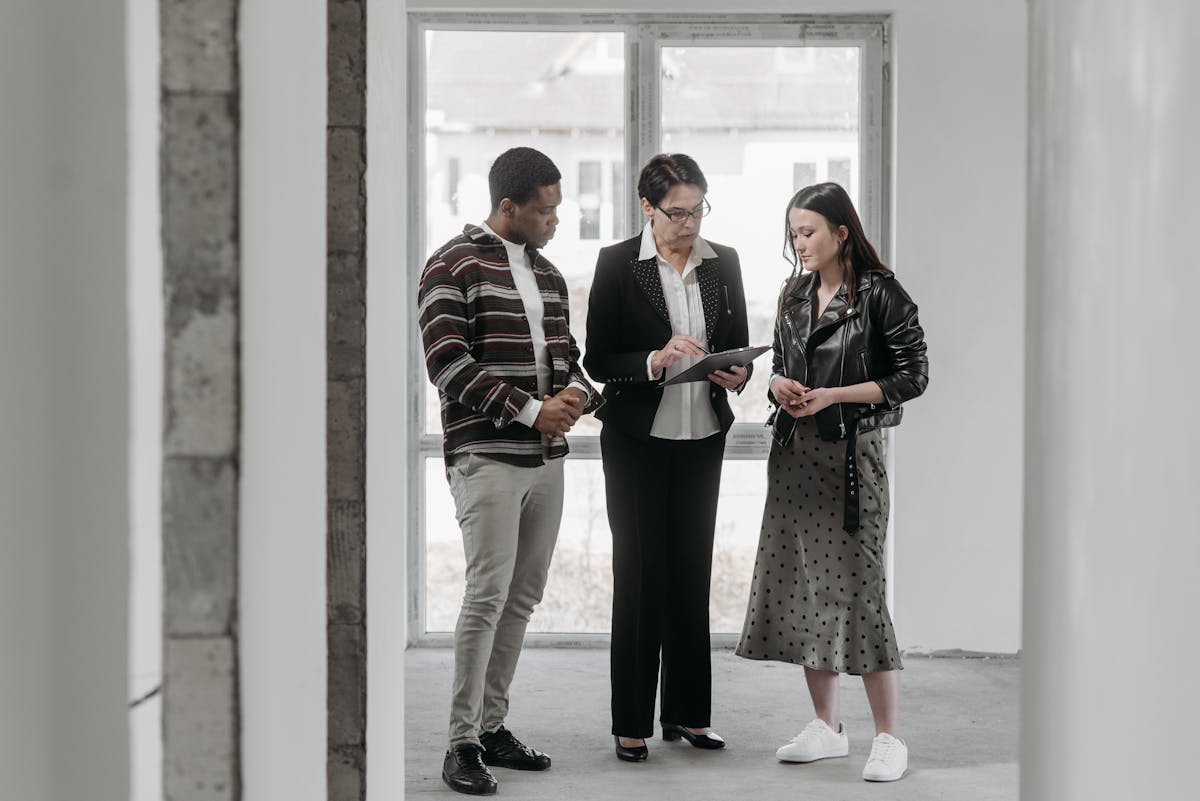 Singapore property agent serving a client at a counter with phone in hand, representing organised WhatsApp lead management