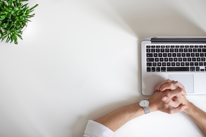 Professional working at a laptop, representing the shift from manual spreadsheet tracking to automated lead management