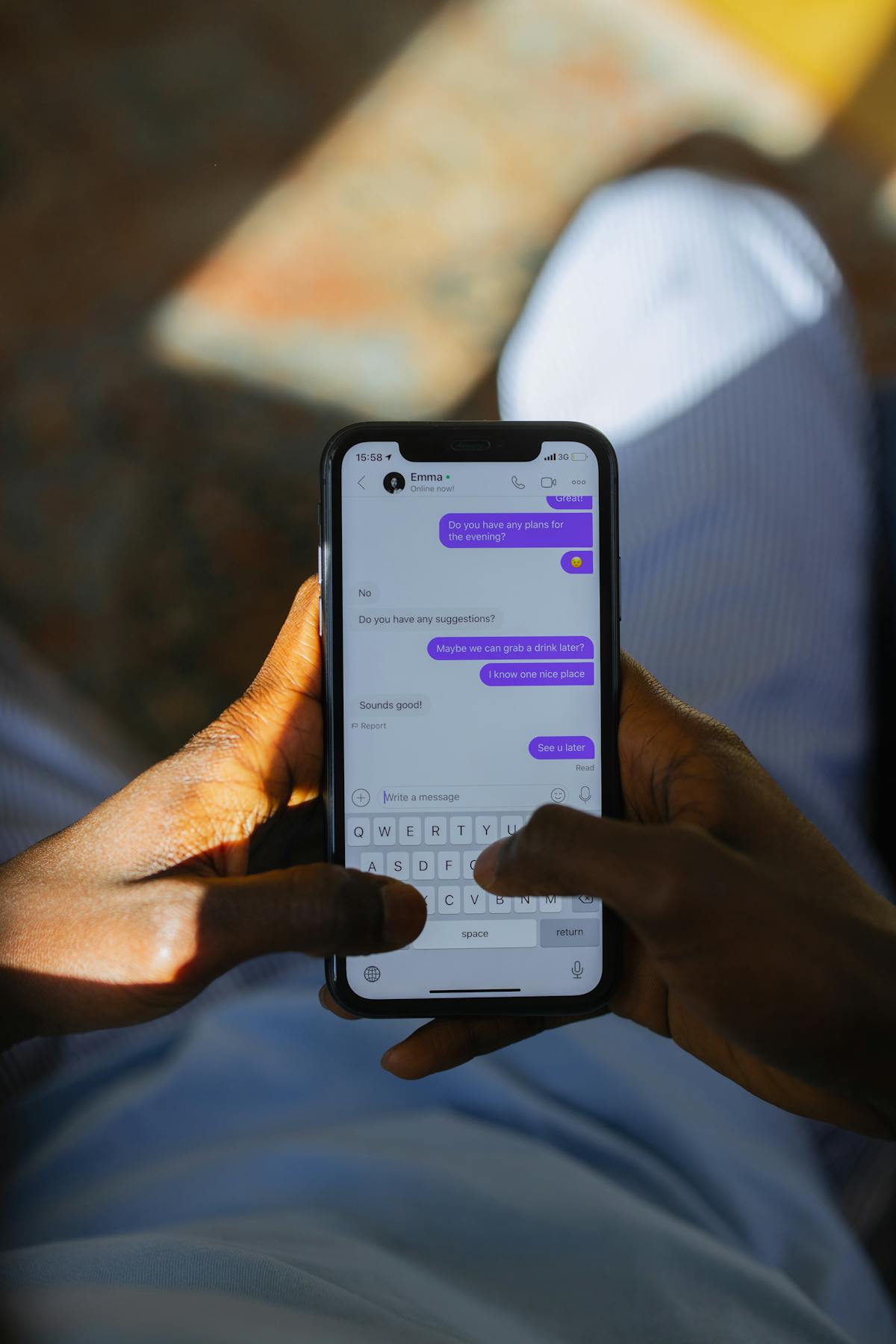 Hands typing a chat message on a smartphone with an active conversation thread on screen, representing a Singapore property agent drafting a post-viewing WhatsApp follow-up