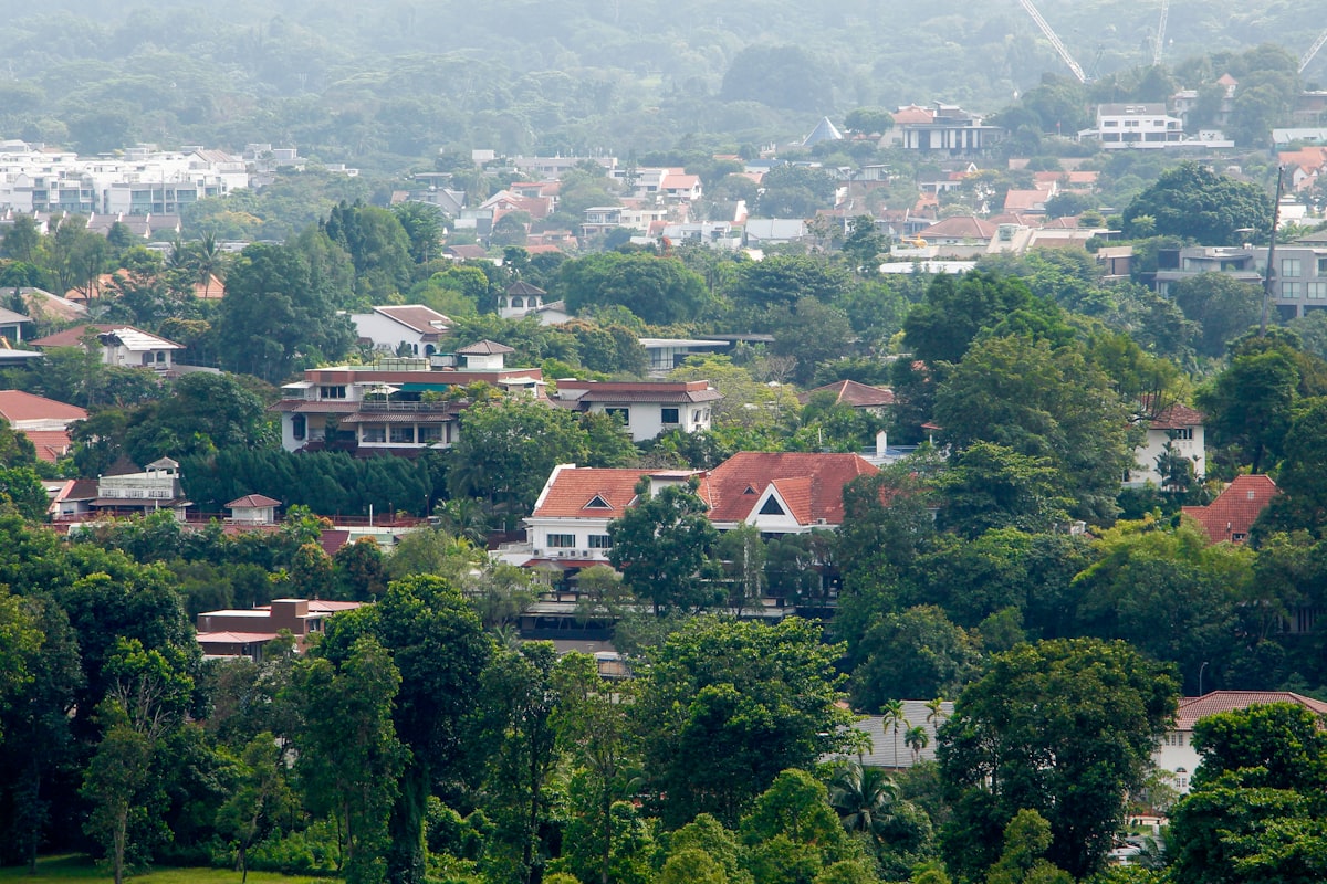 Aerial view of Singapore landed property estate with bungalows among tropical greenery