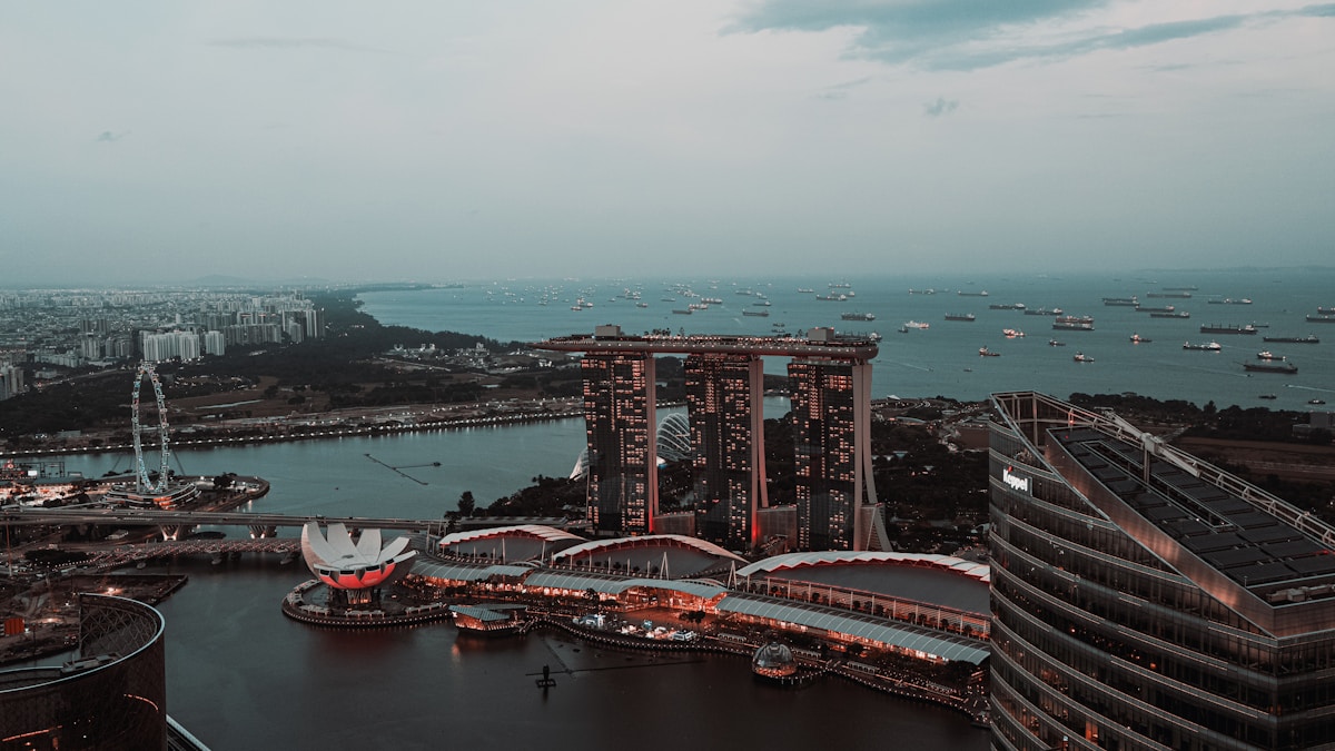 Aerial view of modern condominium towers in Singapore with lush greenery and city skyline