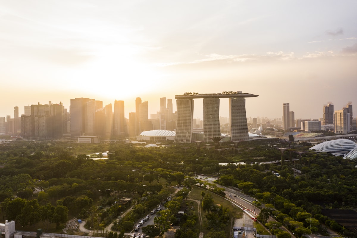 Aerial view of Singapore city centre with river running through it and high-rise buildings