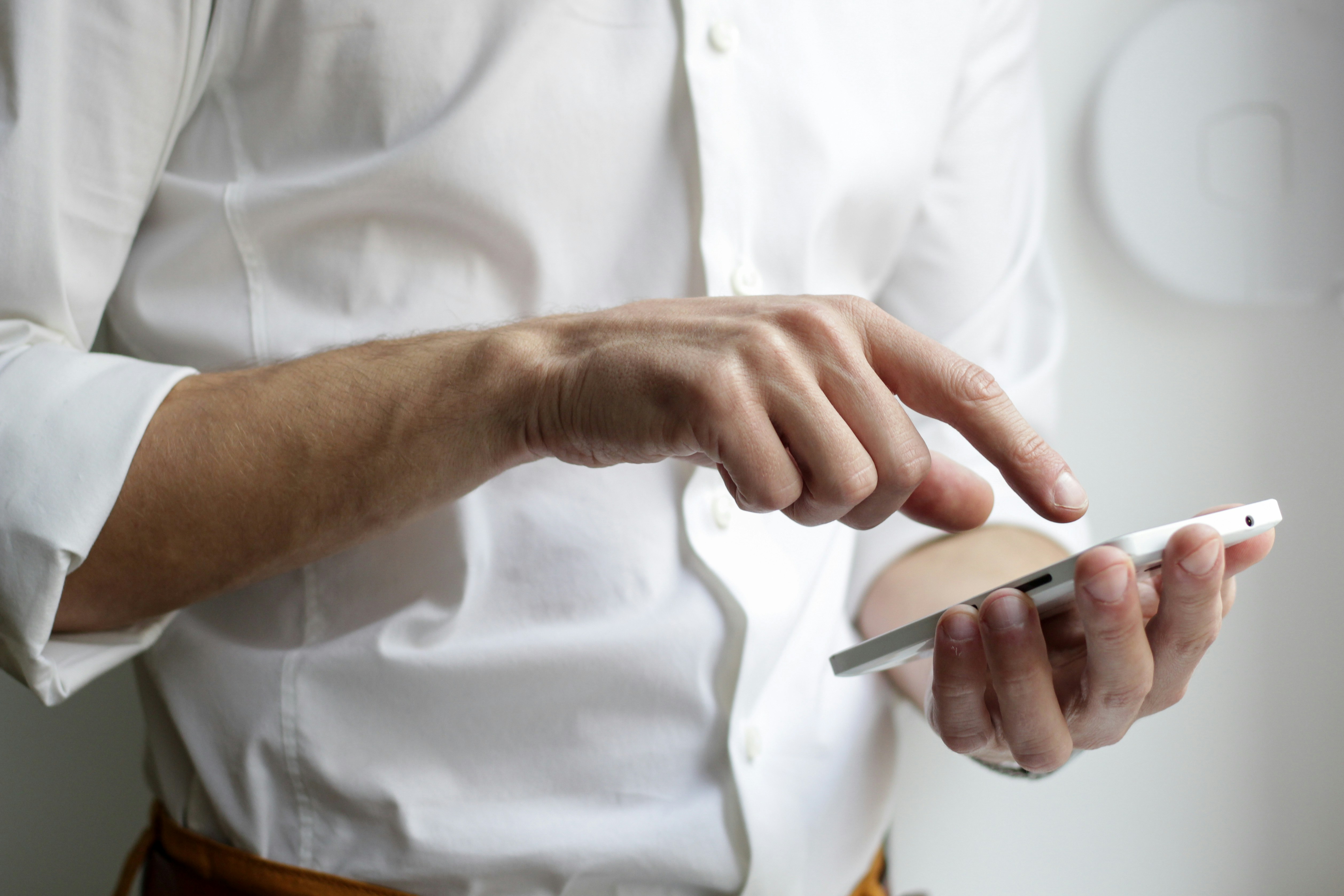 Professional texting on smartphone, representing follow-up messaging to property leads via WhatsApp