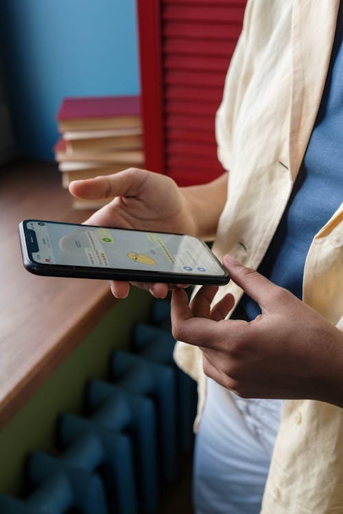 Property agent texting on smartphone representing mobile-first WhatsApp lead management